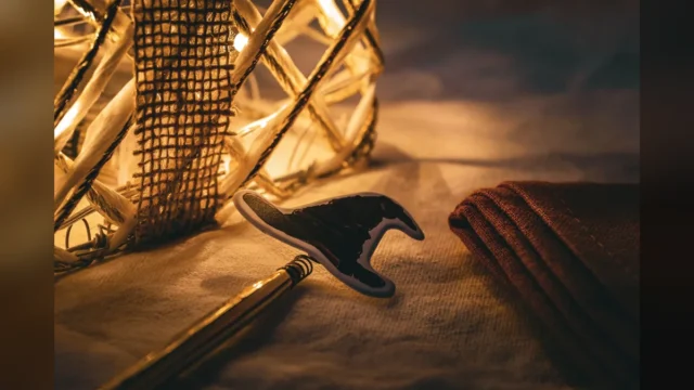 Warm ambiance with illuminated wicker decor, pen, and fabric creating a cozy setting.